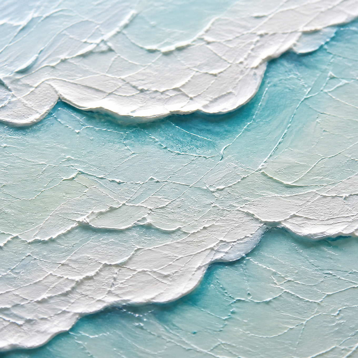 Close-up of raised white surf and pale aqua hand-painted texture.