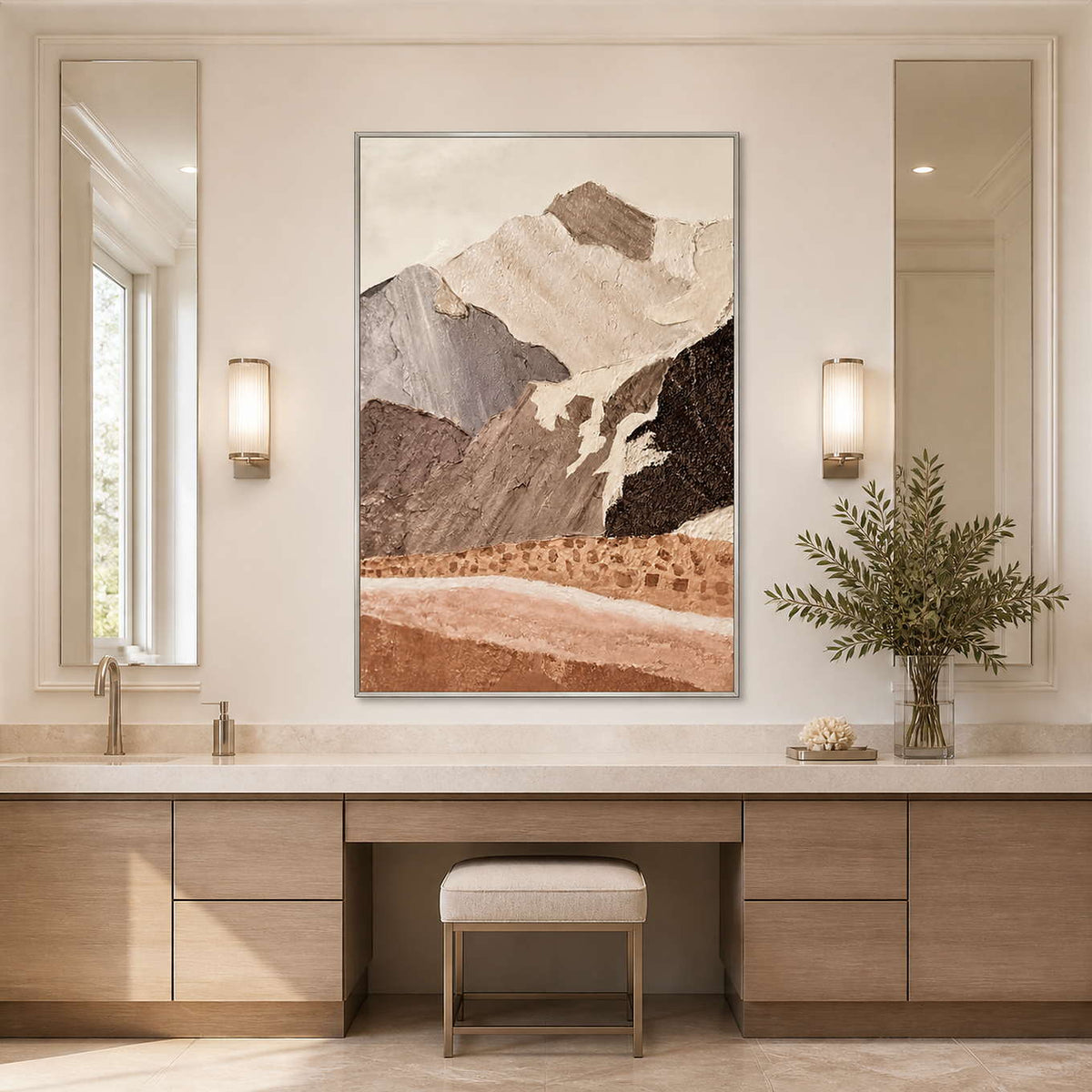 Silver framed earthy mountain artwork above a pale vanity between tall bathroom mirrors.