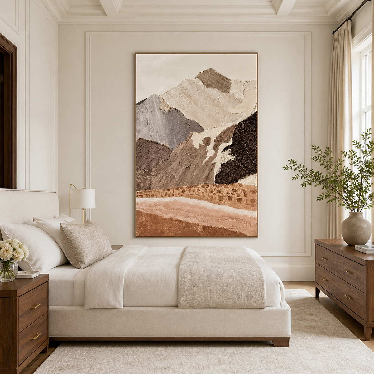 Wood framed earthy mountain artwork beside a cream bed and wooden dresser.