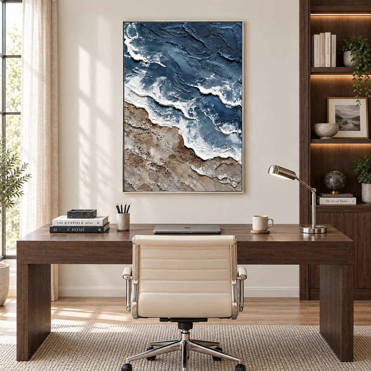 Beyond the Shore in a silver frame above a dark wood desk with a cream office chair.