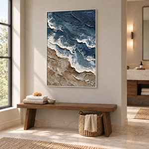 Beyond the Shore in a white frame above a wood bench with folded towels beside a bathroom vanity.