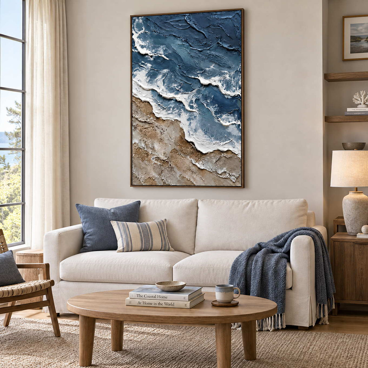 Beyond the Shore in a wood frame above a cream sofa with blue cushions and a dark blue throw.