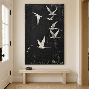 White birds flying across a charcoal-black sky without an outer frame, displayed above an entryway console.