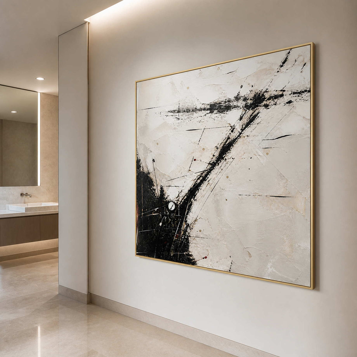 Square black and ivory wall art in a bathroom with a gold frame.