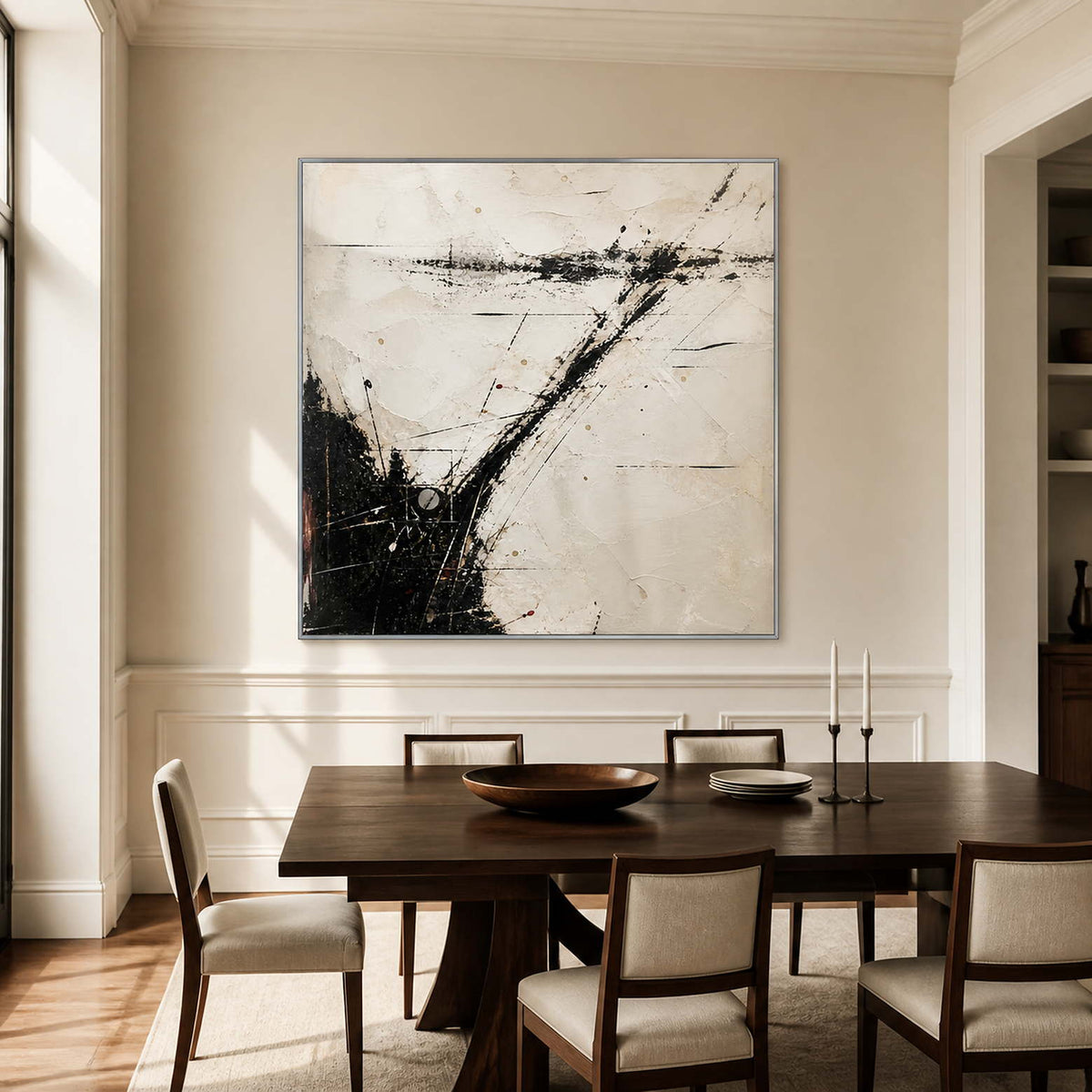 Dynamic black and white wall art in a dining room with a silver frame.