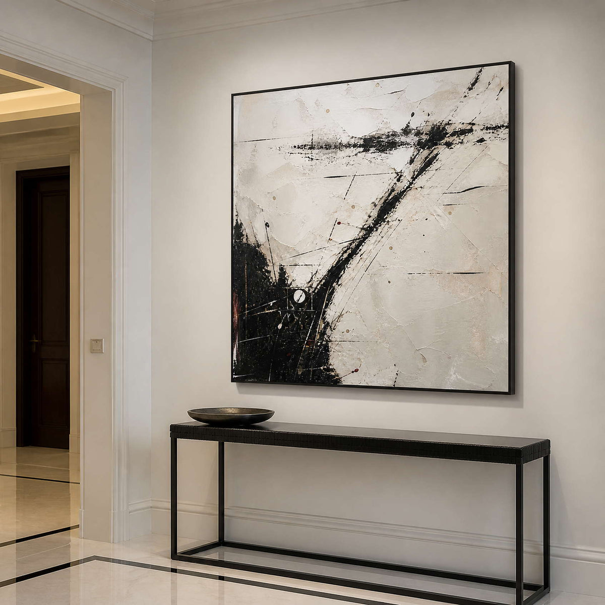 Expressive abstract wall art in an elegant entryway with a black frame.