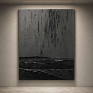 Textured monochrome artwork viewed close-up on an art gallery wall.