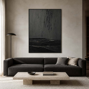 Textured black abstract wall art displayed in a neutral modern living room.