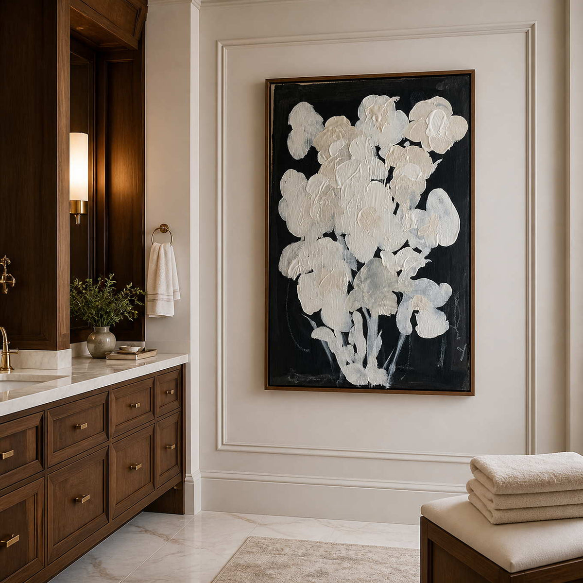 Wood framed cream floral artwork beside a stone vanity in a bathroom dry area.