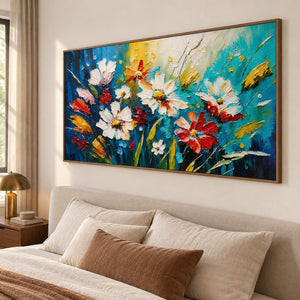 Hand-painted panoramic floral wall art in cobalt, turquoise, white, red, and yellow, displayed in a bedroom in a brown wood frame.