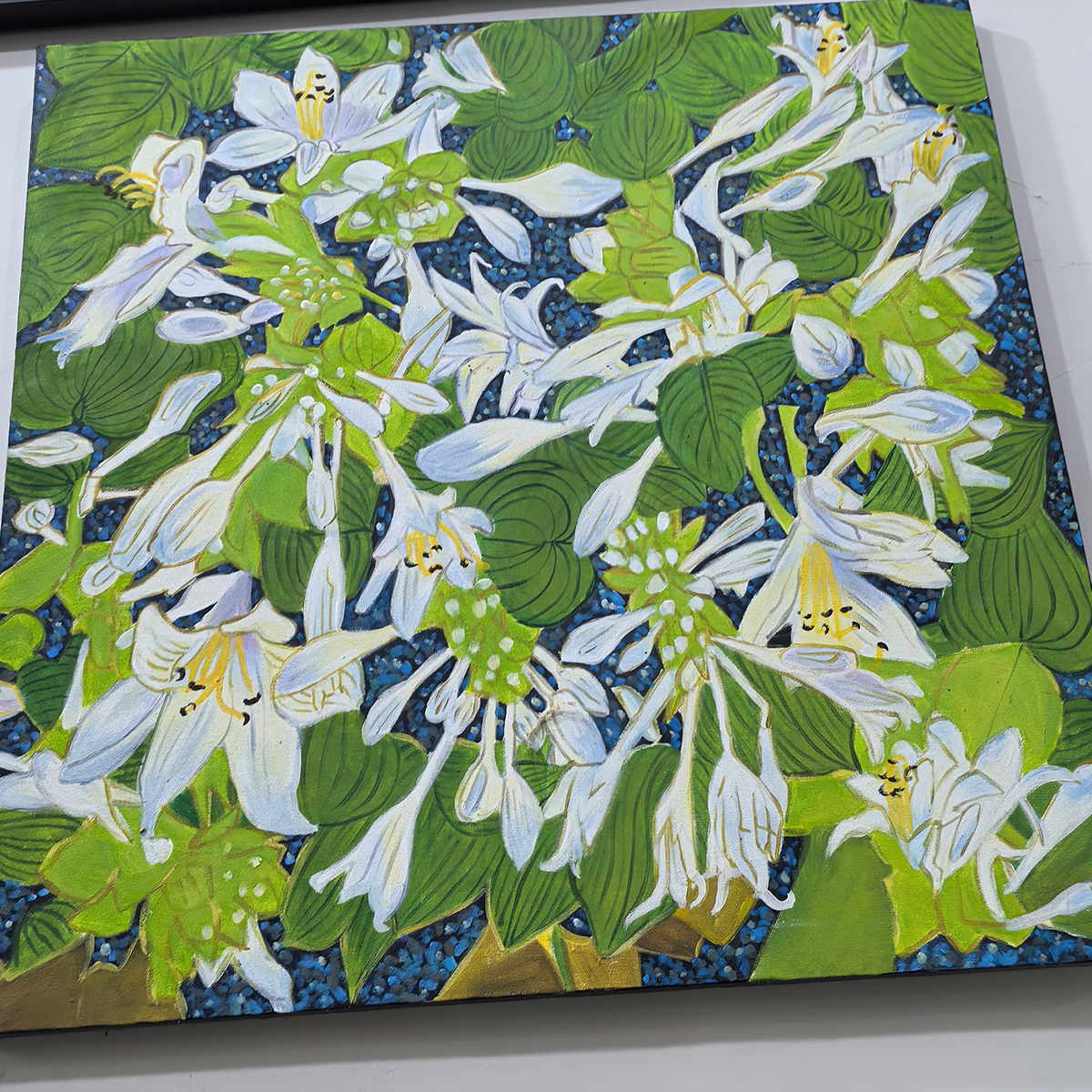 Angled close view of white flowers, curled petals and overlapping green leaves.
