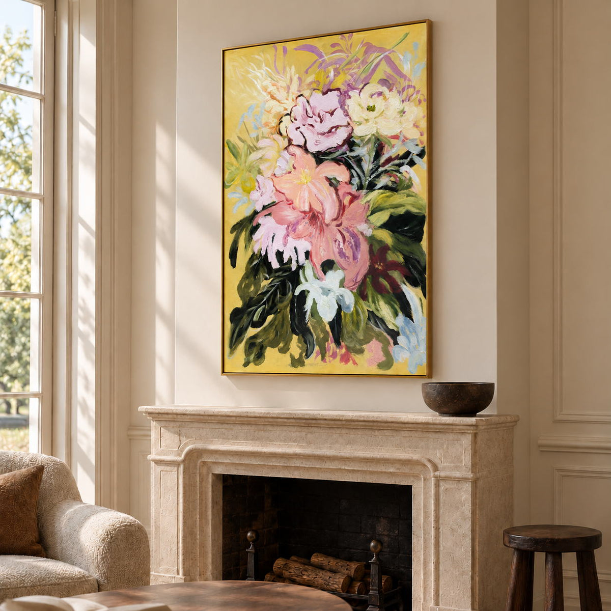 Large pink and cream flowers with dark green leaves on a warm yellow ground in an artwork with a gold-colored frame, displayed above a fireplace.