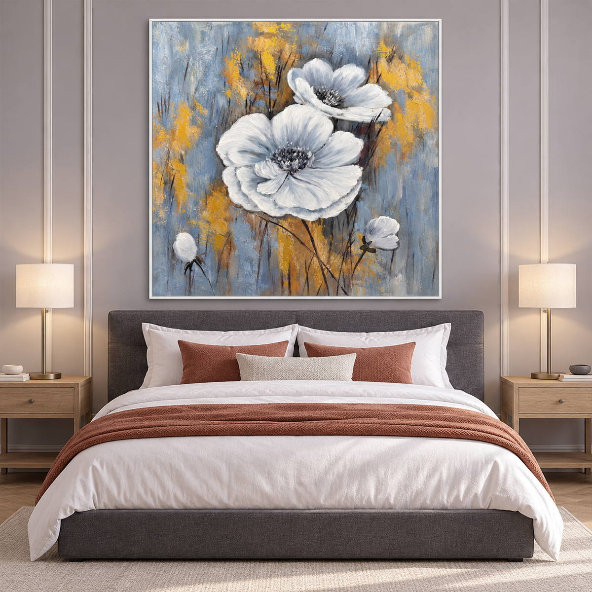 Two large white flowers and small buds on a blue-gray ground with ochre marks in an artwork with a white frame, displayed in a bedroom near the bed.
