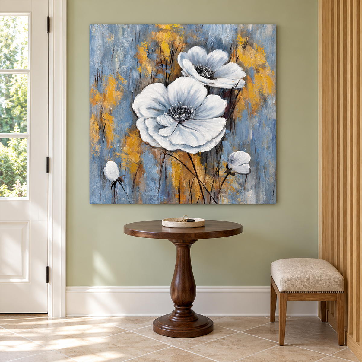 In an entryway above a console or bench, an artwork with no outer frame shows two large white flowers and small buds on a blue-gray ground with ochre marks.