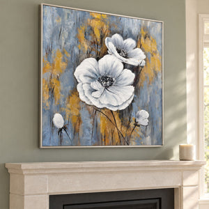 Above a fireplace, an artwork with a silver-colored frame shows two large white flowers and small buds on a blue-gray ground with ochre marks.