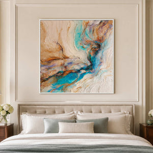White framed turquoise abstract artwork above a bed with cream pillows and muted blue bedding.