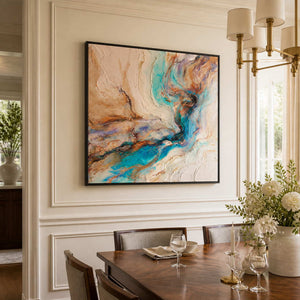 Black framed turquoise abstract artwork beside a dining table set with wine glasses.