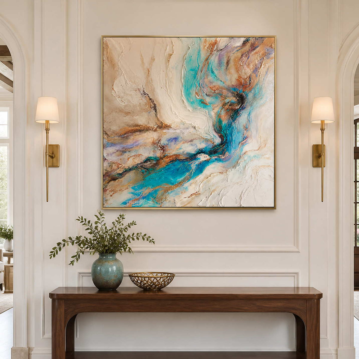 Gold framed turquoise abstract artwork above a hallway console between paired wall lamps.