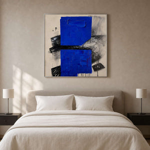 Cobalt blue abstract wall art above a warm minimalist bedroom.