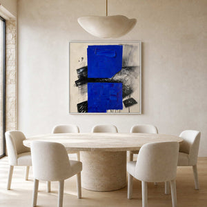 Blue textured abstract painting in a bright neutral dining room.