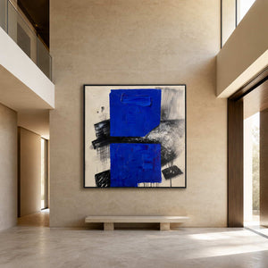 Large blue abstract painting in a double-height modern foyer.