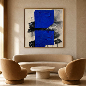 Cobalt blue modern wall art in a warm boutique hotel lounge.