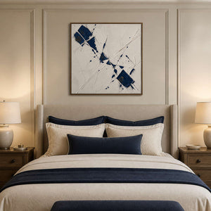 Blue minimalist abstract wall art styled above a warm neutral bed.
