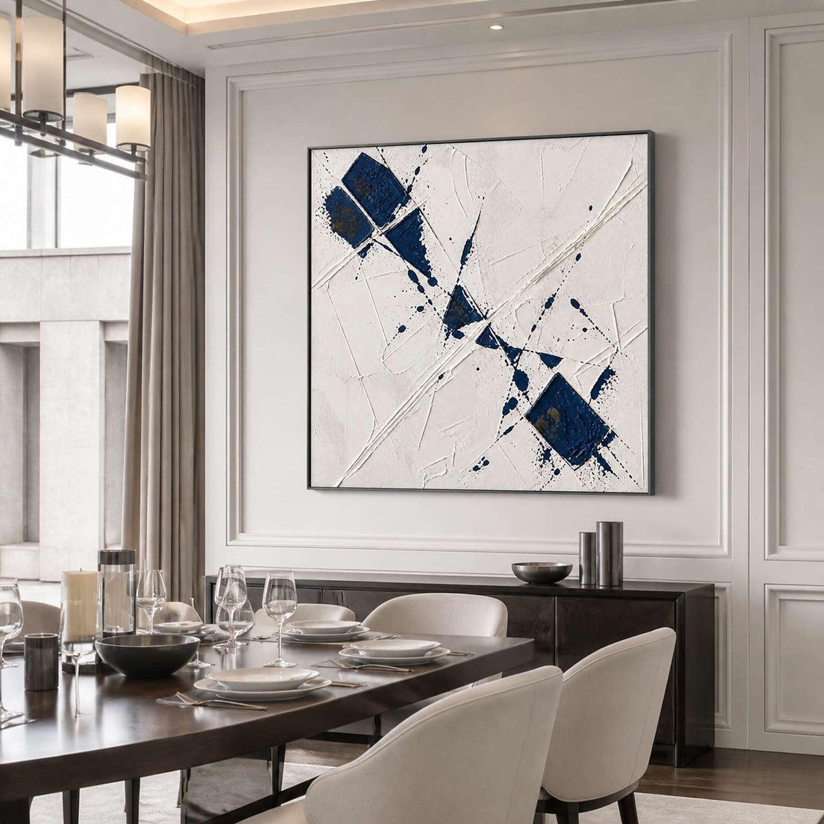 Navy and ivory abstract wall art displayed beside a contemporary dining table.