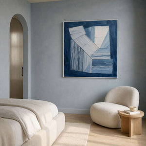 Indigo and white geometric forms wall art in a contemporary bedroom.