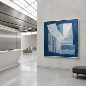 Indigo and white geometric forms wall art in a contemporary commercial lobby.