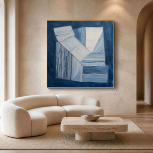 Indigo and white geometric forms wall art in a contemporary living room.