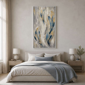 Blue and gold vertical wall art displayed in a minimalist primary bedroom.