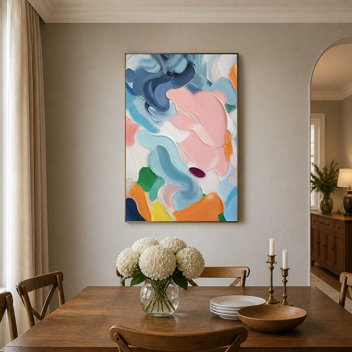 Blush and blue abstract wall art adds fresh color above a wood dining table.