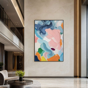 Vertical colorful abstract art displayed in a contemporary hotel lobby.
