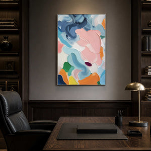 Modern blush and blue abstract painting in a dark wood office.