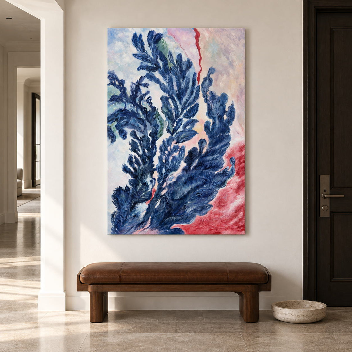 Branching deep blue forms curling upward over pale pink, cream and red in an artwork with no outer frame, displayed in an entryway above a console or bench.