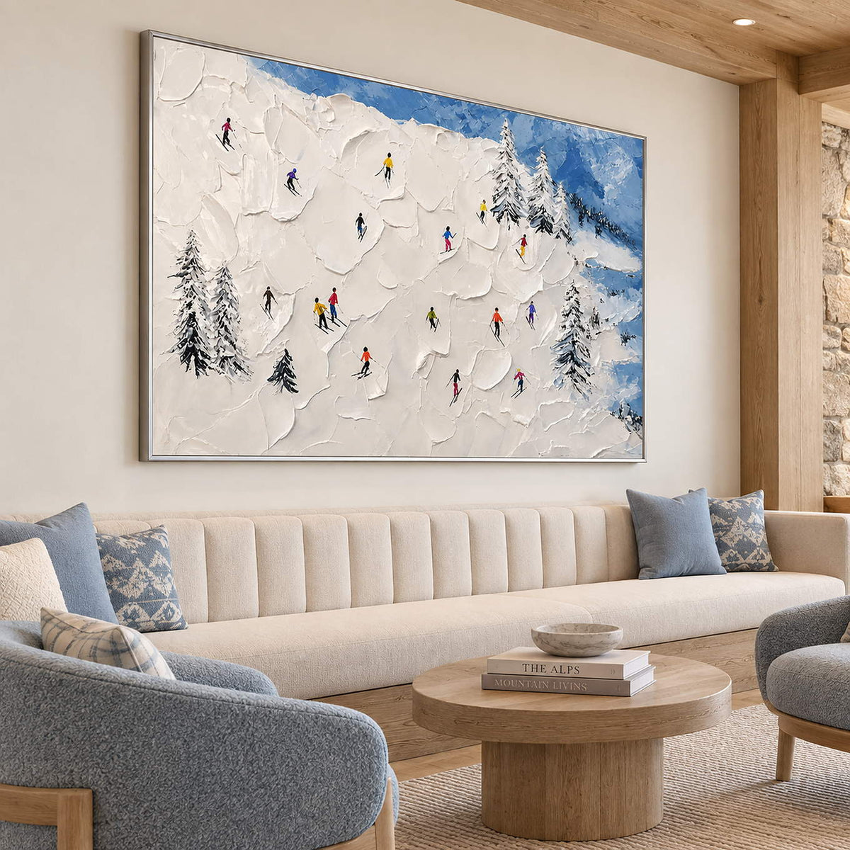Hand-painted snowy mountain canvas with colorful skiers and pine trees, displayed in a lounge in a silver frame.