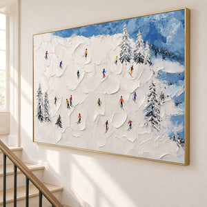 Hand-painted snowy mountain canvas with colorful skiers and pine trees, displayed beside a staircase in a gold frame.