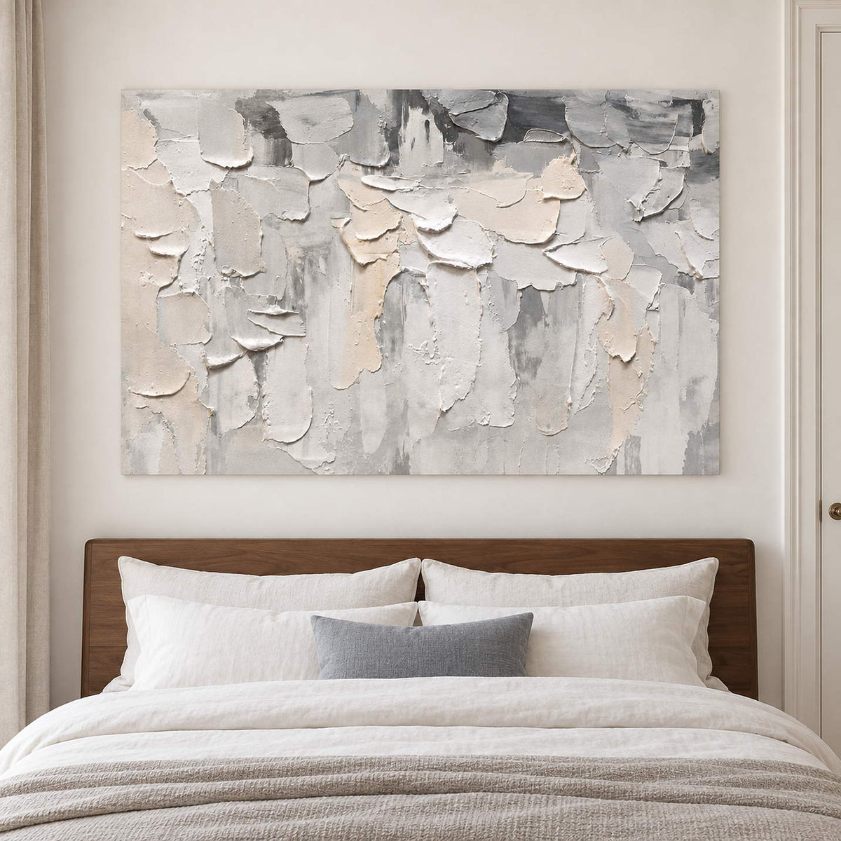 Overlapping ivory and gray raised strokes on a pale ground without an outer frame, displayed above a bed.