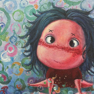 Close-up of the character's wide eyes, dark hair and red-pink face against colored rings.
