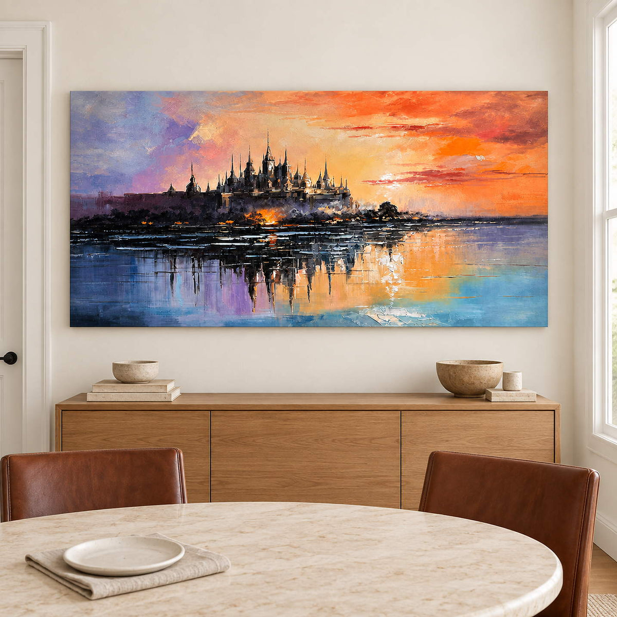 A distant castle reflected in water beneath an orange sunset without an outer frame, displayed above a dining table.