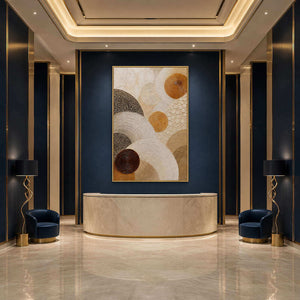 Layered circles in gold, brown, and ivory wall art in a contemporary hospitality lounge.