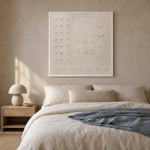 White geometric wall art in a calm oatmeal-toned bedroom.