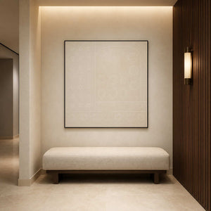 Ivory geometric artwork displayed in a softly lit hotel corridor.