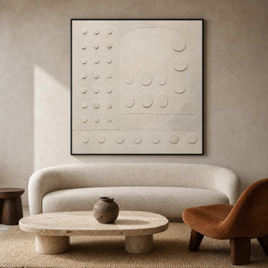 Ivory geometric relief artwork in a softly brutalist living room.