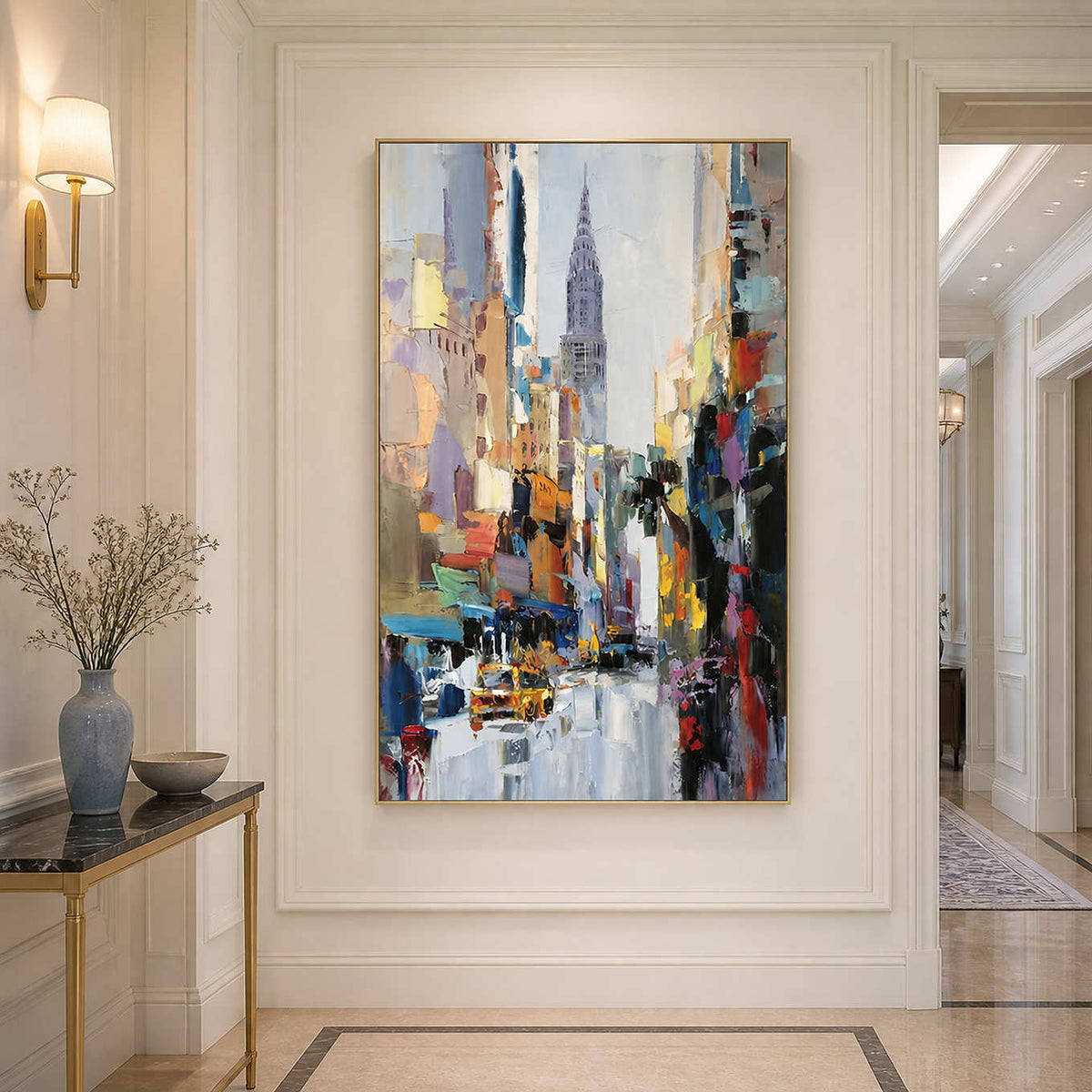Gold framed colorful cityscape in a bright hallway beside a narrow marble console.