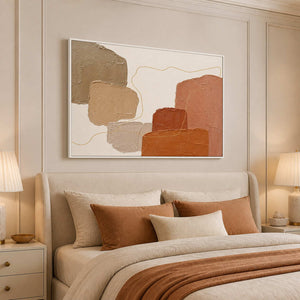 Terracotta and neutral abstract wall art styled above a warm bed.