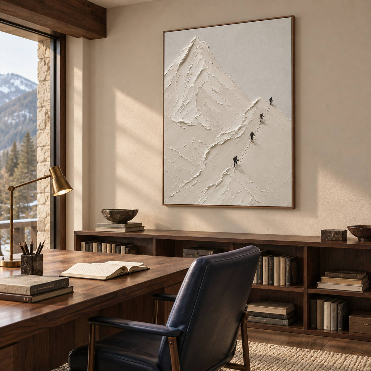 Four climbers ascending sculpted white mountain ridges in a vertical composition, displayed in a study in a brown wood frame.