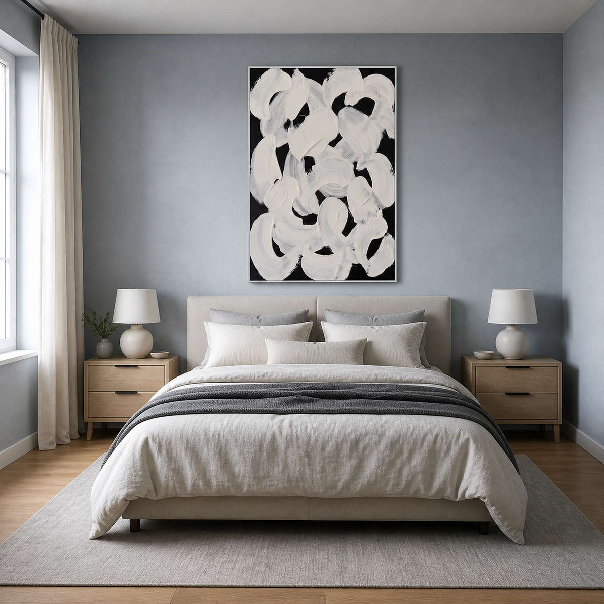 White framed curved brushwork above a linen bed against a blue gray wall.