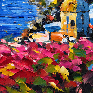 Detail of pink foreground flowers and a yellow-domed building beside blue water.